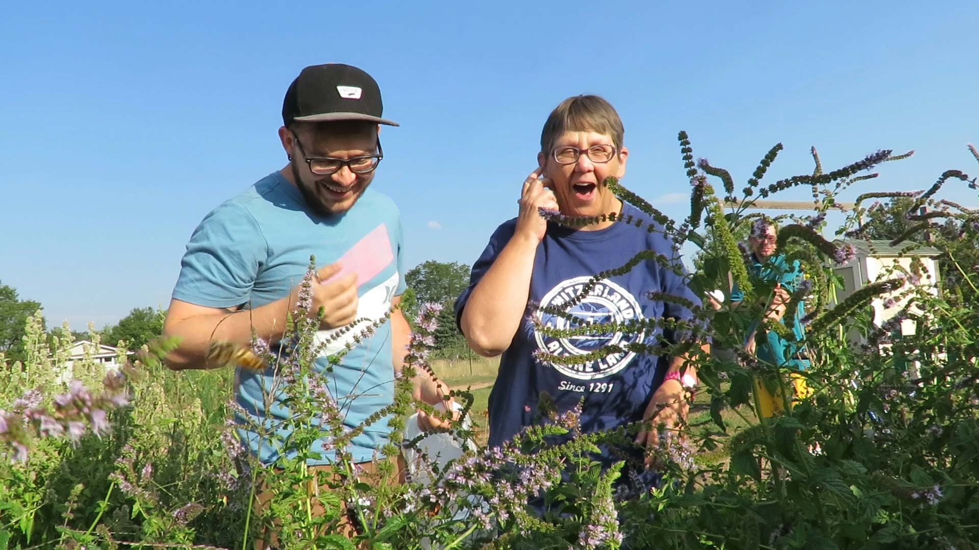 Adults with disabilities outdoors in a field having fun.